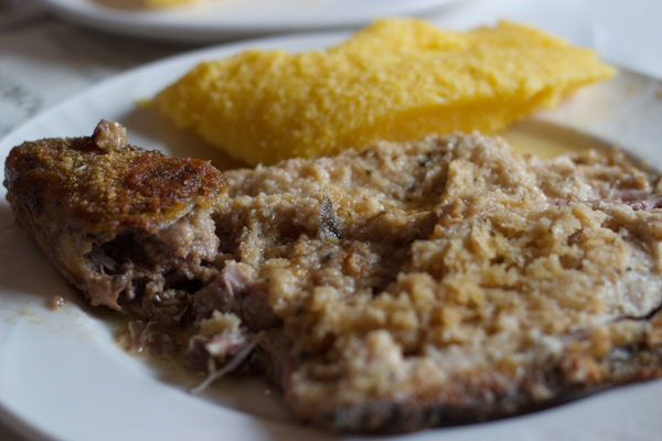 Tinca al forno (baked tench stuffed with bread and served with polenta- the local specialty)
