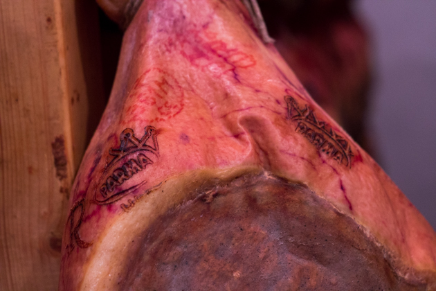 The markings on the prosciutto ensuring the pig  was bred, slaughtered and cured within regulations