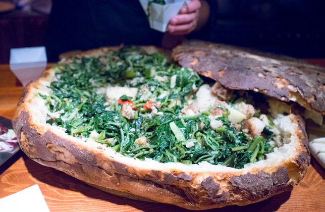 Pancotto (bread filled with boiled broccoli rabe, onions, wild chicory, cabbage, cherry tomatoes, garlic, bay leaves and chilli served with olive oil)