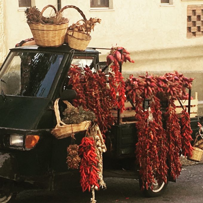 A tre ape cart selling local Calabrian products: chillies, oregano and Tropea onions