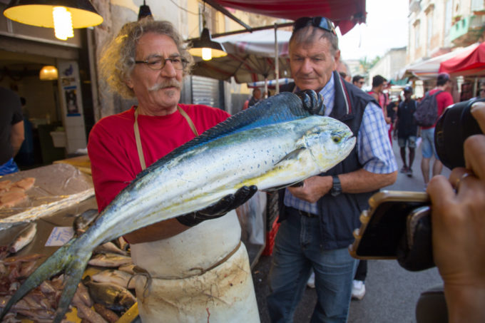 Vendor showing off his fish