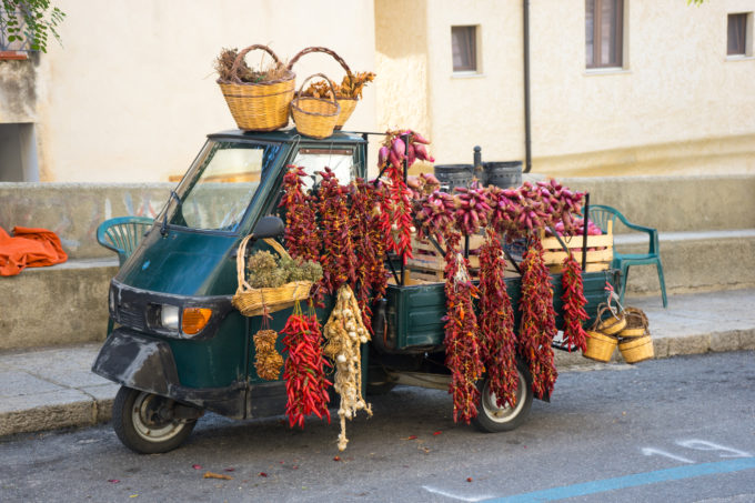 A tre ape (three wheeled vehicle typical in Italy) selling local ingredients such as chillies, garlic, onions and oregano
